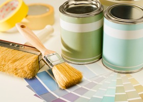 A selection of painting supplies swatch, brush and can