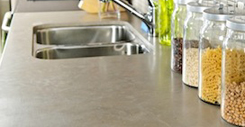 Modern small kitchen interior with glass jars on natural stone countertop