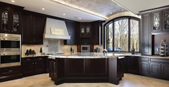 Large kitchen in luxury home with dark wood cabinetry