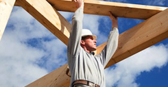 carpenter at work with wooden  roof construction