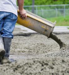 man guiding flowing concrete