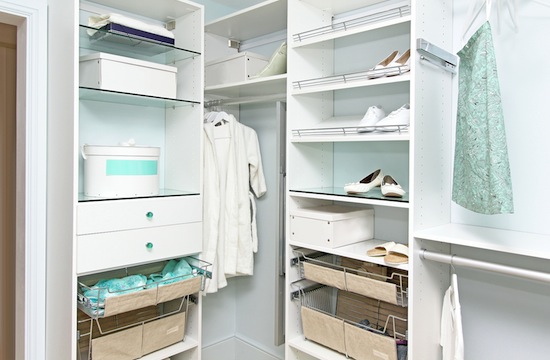 Detail of large walk in closet with modern wardrobe on hangers