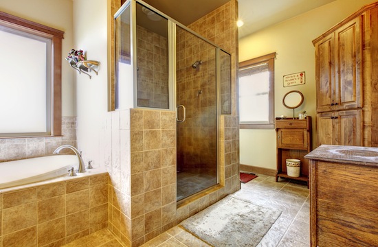 Large bathroom with wood furniture and natural colors.