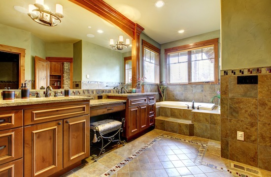 Luxury large master bathroom in mountain home with double sink and green walls.