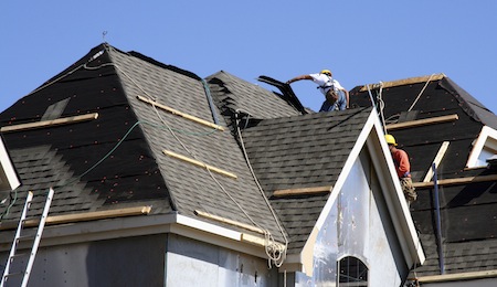 Construction workers using a roofing system