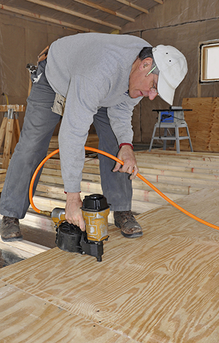 man using a nail gun