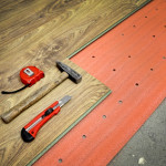 Flooring of room, laminate, foam and tools, hammer, meter, cutter