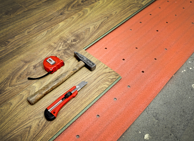 Flooring of room, laminate, foam and tools, hammer, meter, cutter