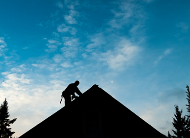 construction worker fixing roof